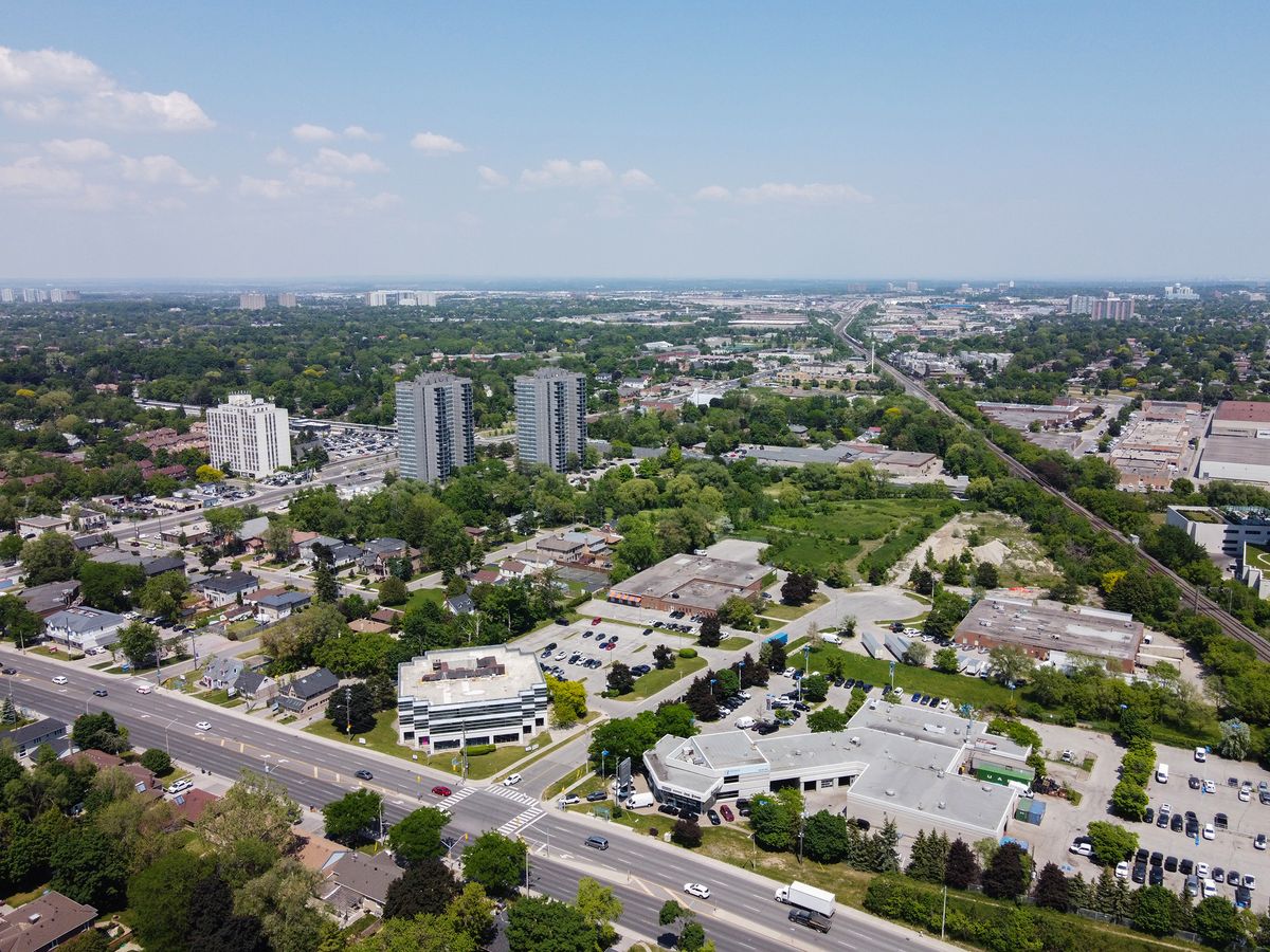 An aerial view of Agincourt in summer, with houses, apartment towers, a main road and a rail line.